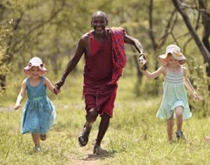 Naboisho-Camp-guide and-children-running-Stevie-Mann-3